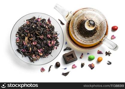 Black tea with natural flavors and a teapot. Top view on white background.. Black tea with natural flavors and a teapot. Top view on white background
