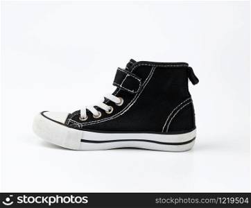 black textile sneaker with white tied shoelaces on a white background, shoes stand sideways