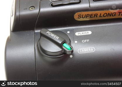 Black videocamera with buttons and switches on a white background