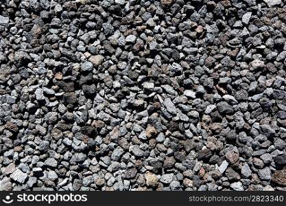 Black volcanic lava stones pattern texture background