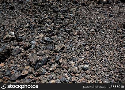 Black volcanic stones soil texture in Lanzarote