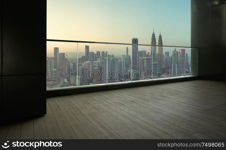 Black wall and wood floor balcony with Kuala Lumpur city background .