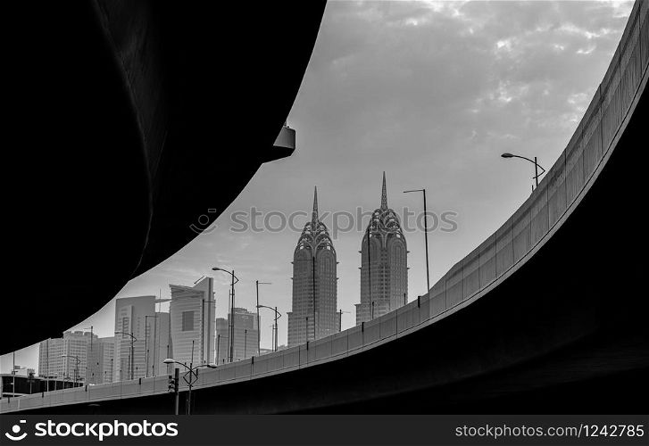 Black white detail pictures of a bridge in Dubai. Skyscraper in the background. Al Kazim Towers in the background.. Al Kazim Towers