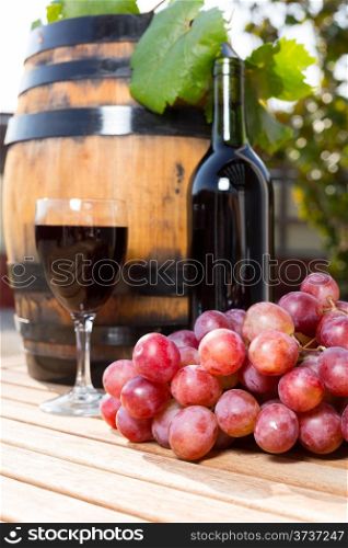 Black wine glass with freshly harvested grapes