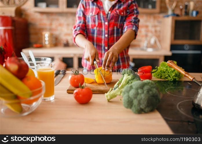 Black woman cooking healthy breakfast on the kitchen. African female person preparing vegetable salad at home. Black woman cooking healthy breakfast on kitchen