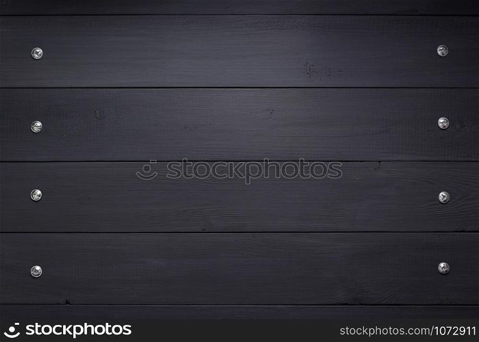 black wooden background as texture surface with screws