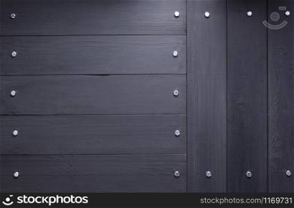 black wooden background as texture surface with screws