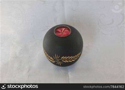 Black wooden decorative candleholder on the table
