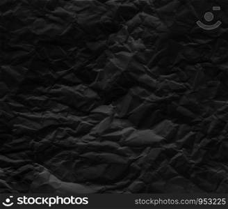 Black wrinkled paper texture background.