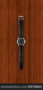 Black wrist watch isolated on dark wooden background. Wrist watch isolated on dark wooden background