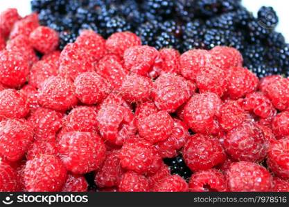 blackberries and raspberries. heap of ripe berries of raspberry and blackberry