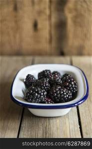 Blackberries in rustic setting with wooden background