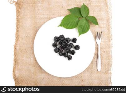 Blackberries on plate and jute
