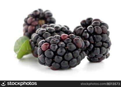 Blackberries with leaves isolated on white background.