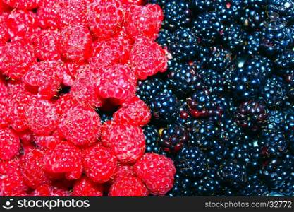 blackberry and raspberry. heap of ripe berries of blackberry and raspberry