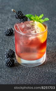 Blackberry Bourbon Smash cocktail garnished with lime and berries