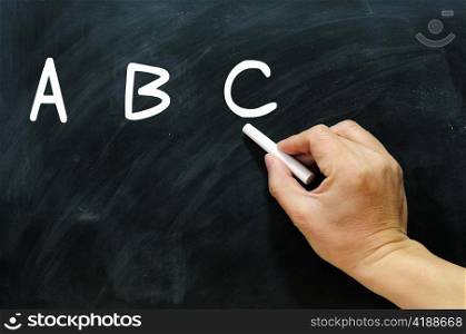 Blackboard / chalkboard. Hand writing ABC with chalk