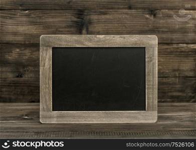 Blackboard chalkboard on wooden background. Vintage texture with copy space for your text