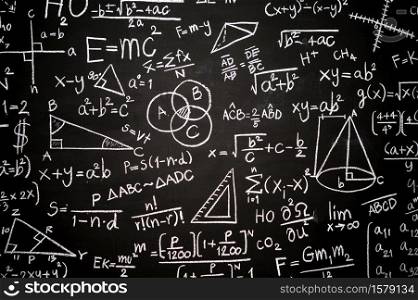 Blackboard inscribed with scientific formulas and calculations in physics, mathematics and electrical circuits. Science and education background.