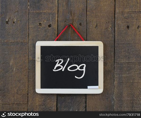Blackboard on a wooden wall with the word Blog.