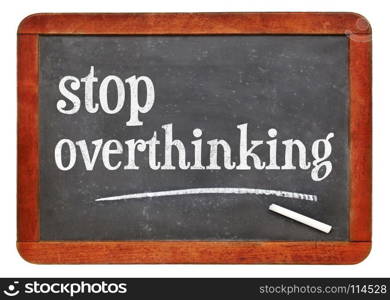 blackboard. Stop overthinking - white chalk text on a vintage slate blackboard