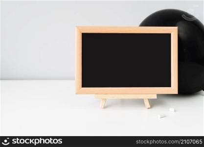 blackboard with chalk front black balloon