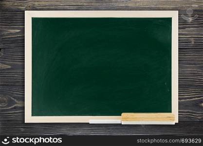 Blackboard with wooden frame, blackboard on old wood background for education concept.