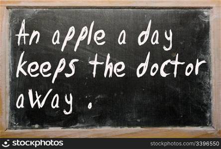 "Blackboard writings "An apple a day keeps the doctor away""