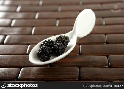 Blackerries in a white spoon