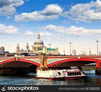Blackfriars Bridge, St. Paul&acute;s Cathedral and cruise boat in London
