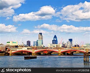Blackfriars Bridge with London skyline behind from Thames river