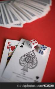 Blackjack cards on red table.