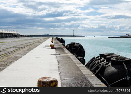 Blacks fenders spherical seats on the edge of a quay to the boats protection