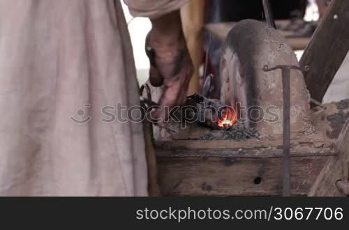 Blacksmith at work 3. Heating of the metal in the furnace.