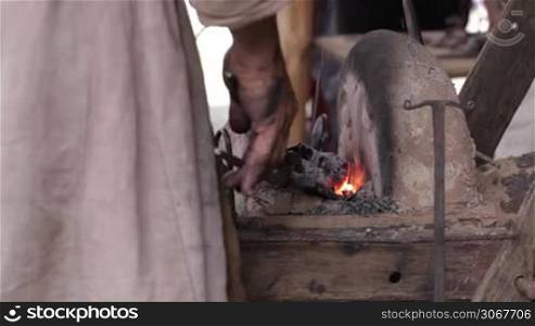 Blacksmith at work 3. Heating of the metal in the furnace.