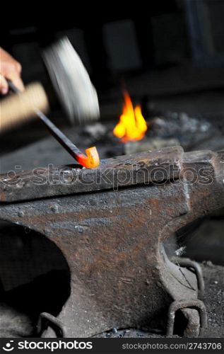 blacksmith forges iron in the forge
