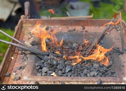 Blacksmith outdoor with coals and fire
