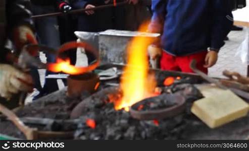 blacksmith puts two hot metal rings at fire, they are disconnected, part2