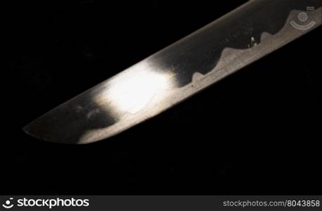 Blade shining in the darkness, horizontal image