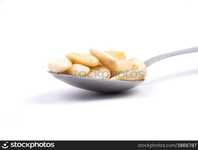 Blanched almonds on spoon