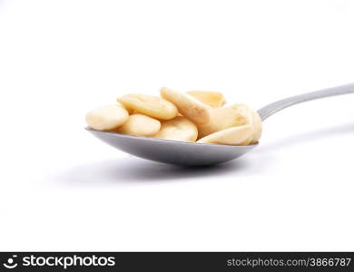 Blanched almonds on spoon