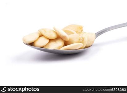 Blanched almonds on spoon