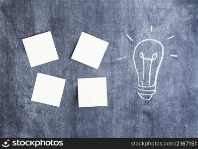 blank adhesive notes light bulb drawn chalkboard