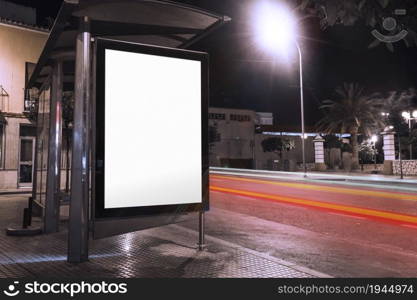 blank advertisement bus shelter with blurred traffic lights night. High resolution photo. blank advertisement bus shelter with blurred traffic lights night. High quality photo