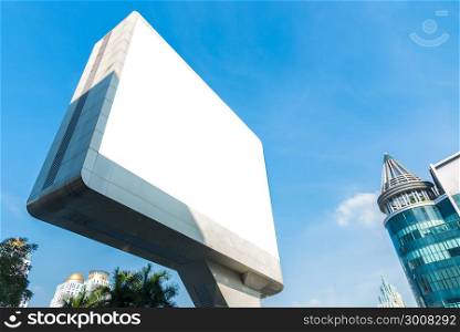 Blank billboard. Blank poster for outdoor advertising. Blank billboard with blue sky and modern building. Big blank billboard for advertisement.