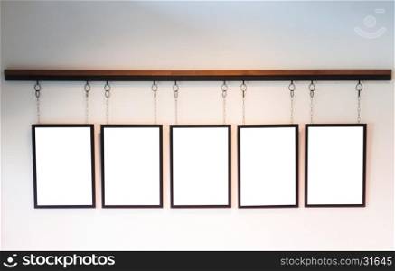 Blank boards hanging on white wall background, stock photo