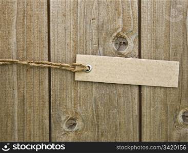 Blank Brown Cardboard Tag On Wooden Background
