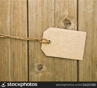Blank Brown Cardboard Tag On Wooden Background