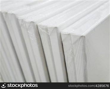blank canvas or poster with pile of canvas