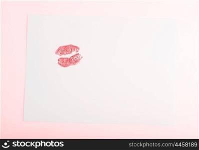 Blank card with red kiss isolated on pink background, conceptual image of love &amp; Valentine&rsquo;s day holiday